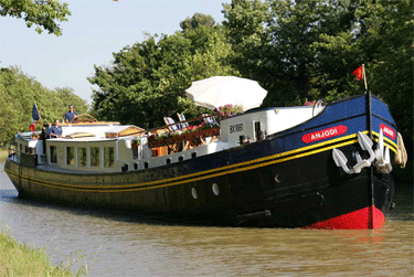 A typical barge in France. Inside is luxury and a sweet cabin.